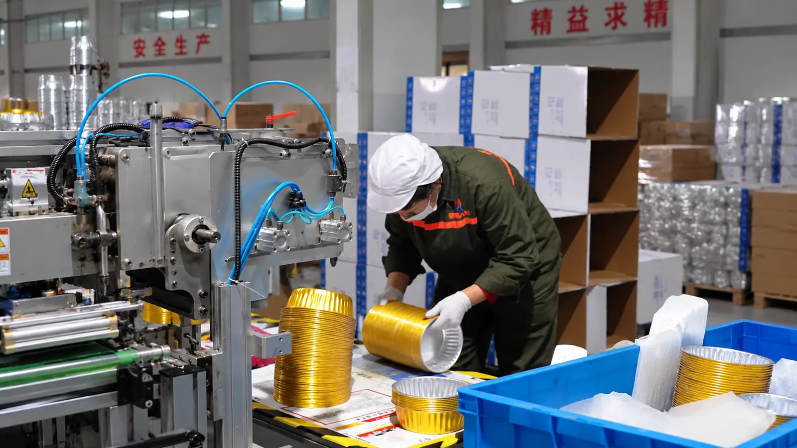 Operator working with aluminum coil processing equipment on the production floor