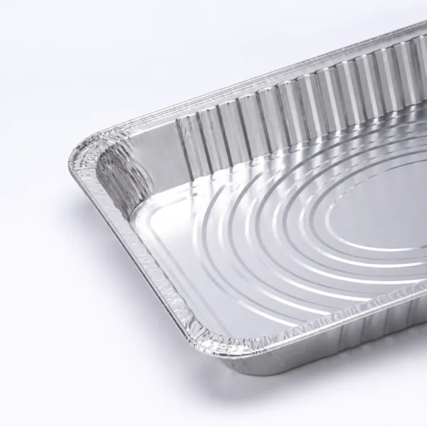 aluminum-foil-steam-table-pan-structure-detail.webp Close-up of the aluminum foil steam table pan showing the crimped rim, formed corner, wrinklewall side and concentric embossed base.
