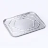 Angled view of half size aluminum foil steam table pan lid