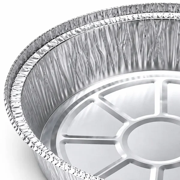 Close-up of the aluminum foil pan's curled rim, pleated inner sidewall and embossed base structure.